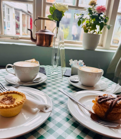 The spotless, warmly lit interior of Cafe Mews, set with fresh bakes and cakes